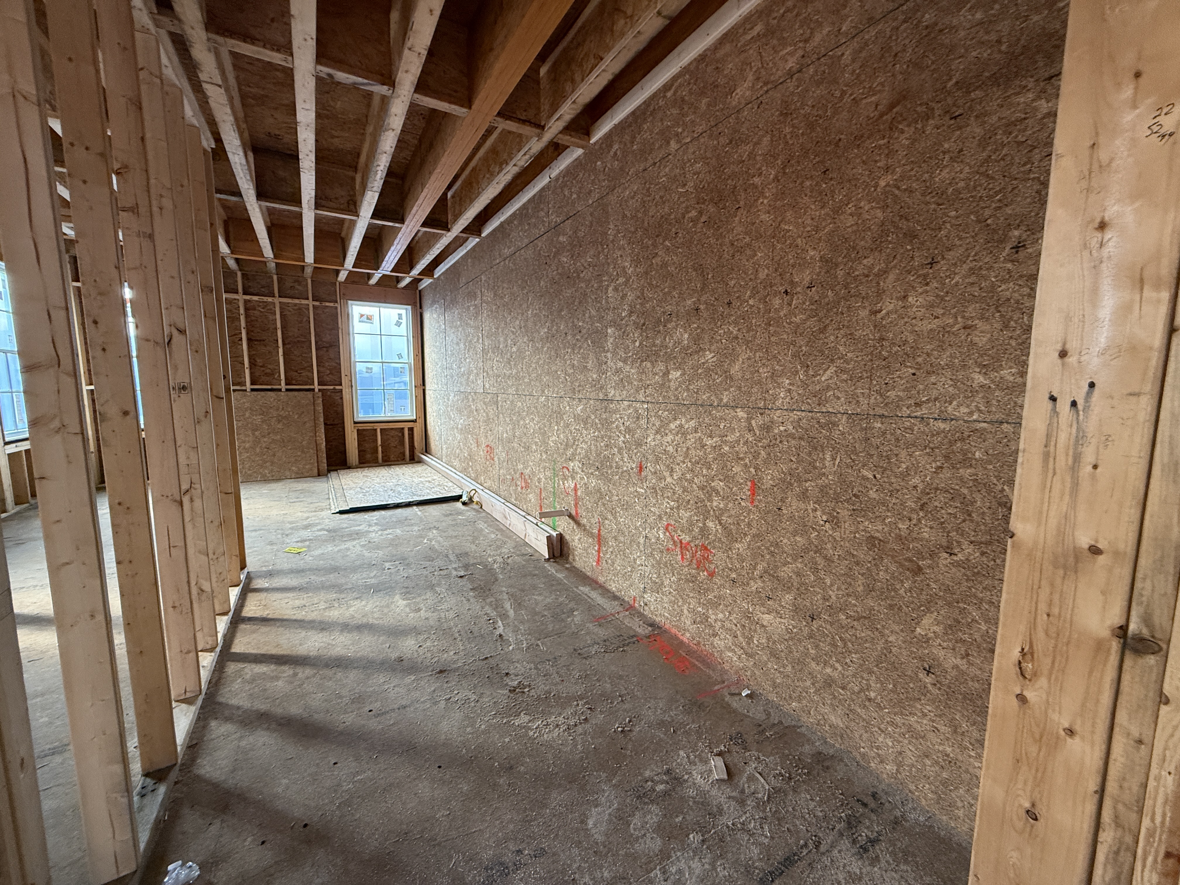 Kitchen at 167 Maverick Street showing white quartz counters and oak flooring (construction phase)