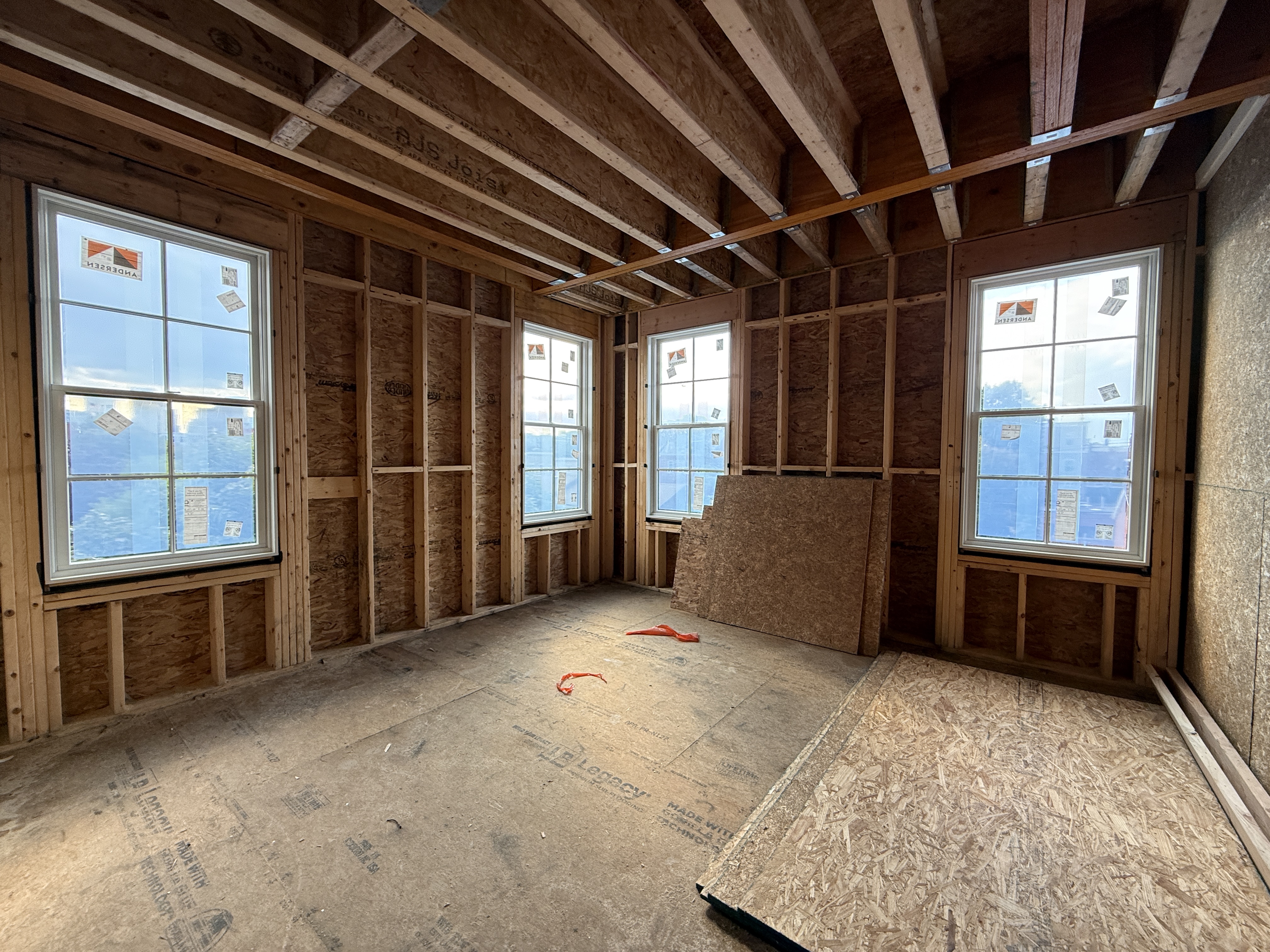 Living room at 167 Maverick Street, virtually staged with modern furnishings (construction phase)